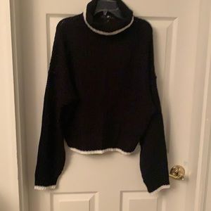 Black sweater polo with a white trim